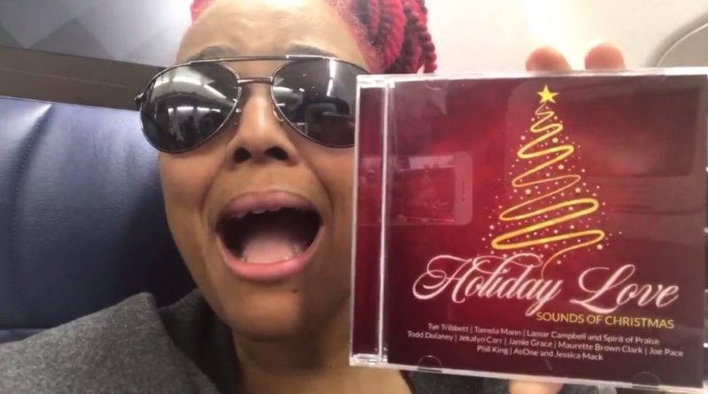 On her way to St. Lucia, Kim promotes the new musical CD for her Holiday Love Christmas special